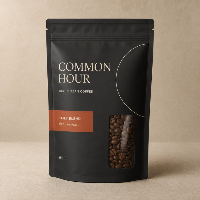 Matte black custom printed pouch with whole coffee beans visible through the clear window